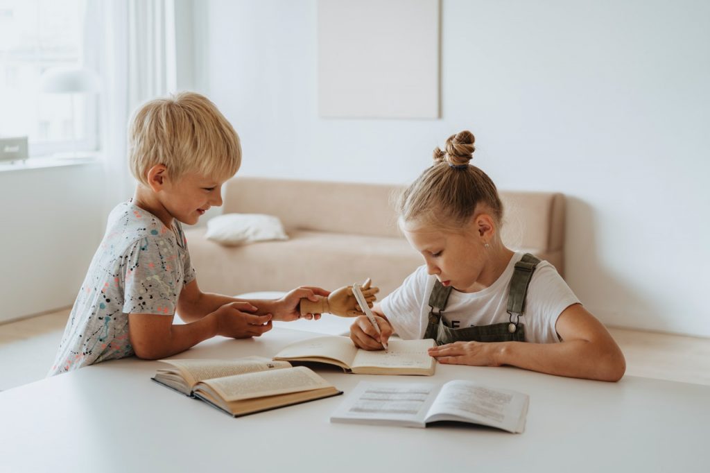 fille et garçon qui font leurs devoirs